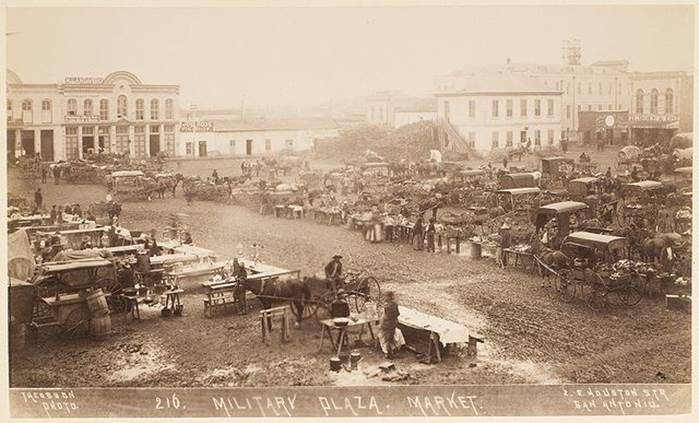 A group of people in a military market
Description automatically generated